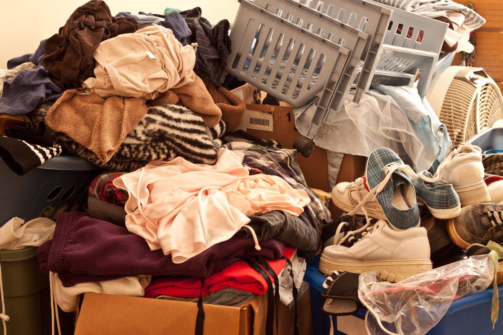 Room full of clothing, baskets, shoes and boxes 