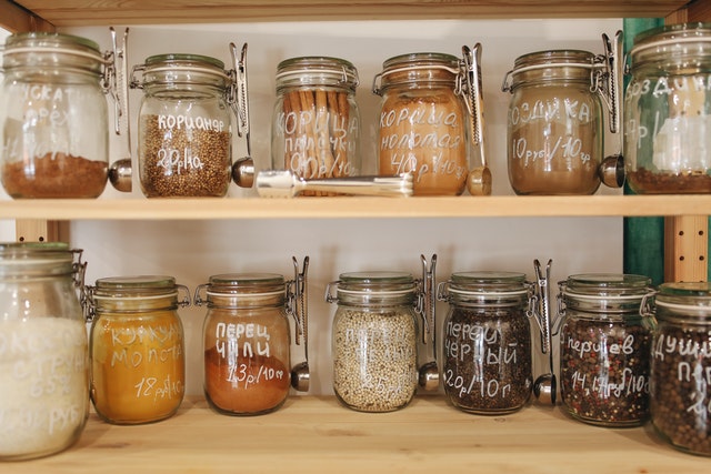 2 shelves of labeled pantry jars 