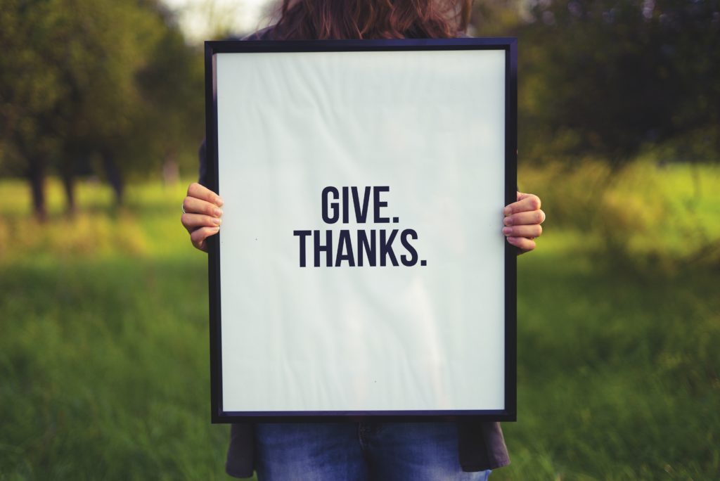 White sign with the words GIve Thanks.